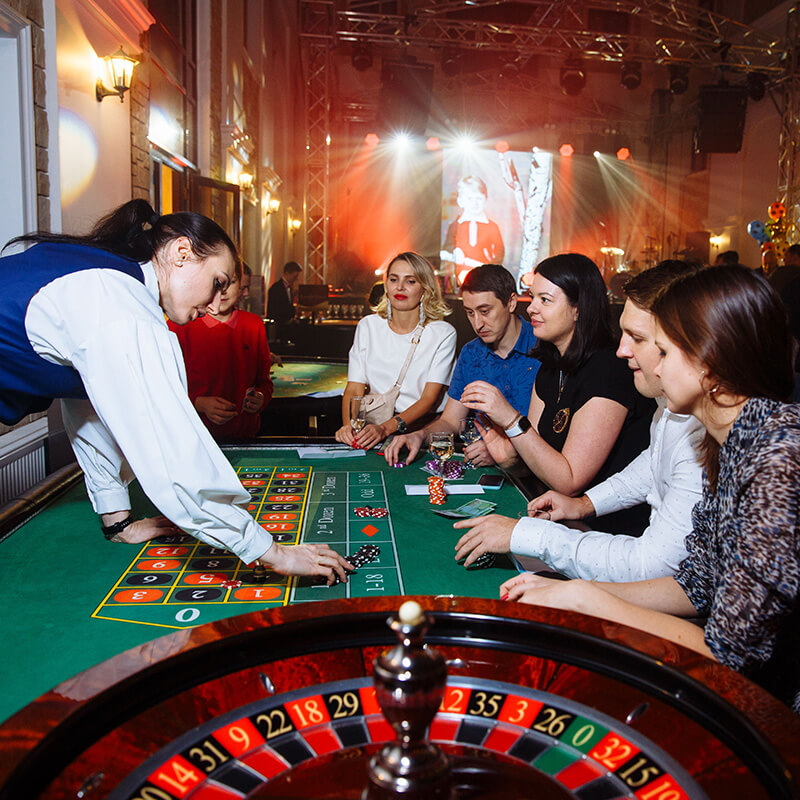 Adult visitors gathered on a busy physical casino floor