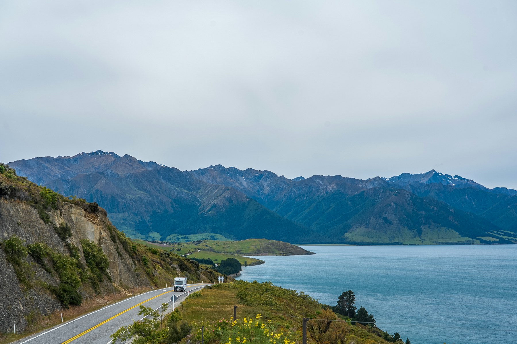 Quiet New Zealand road curving through a green landscape